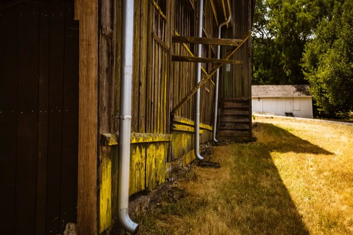 Roof edge, fascia and downspout on a house in Madison, WI, where drip edge carries runoff into the gutter